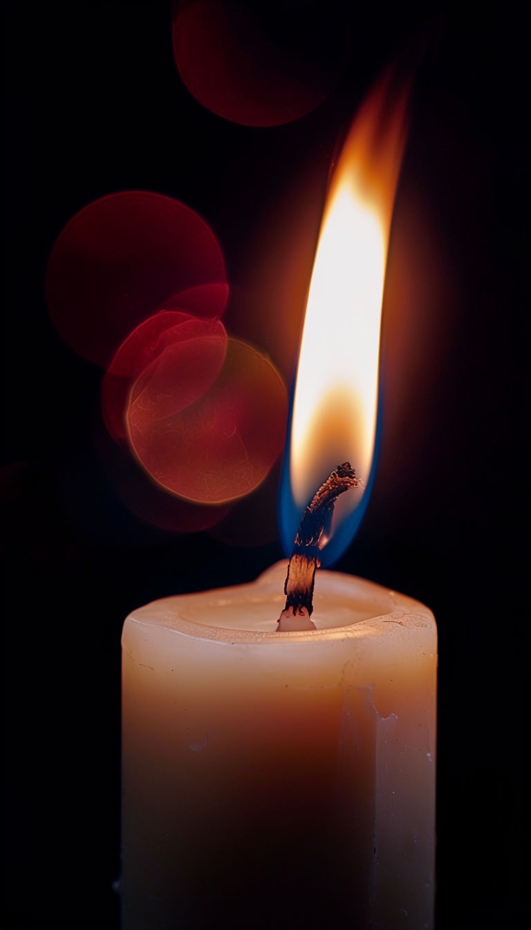 Intense Close-Up of Flickering Candle with Luminous Flame Mobile Wallpaper