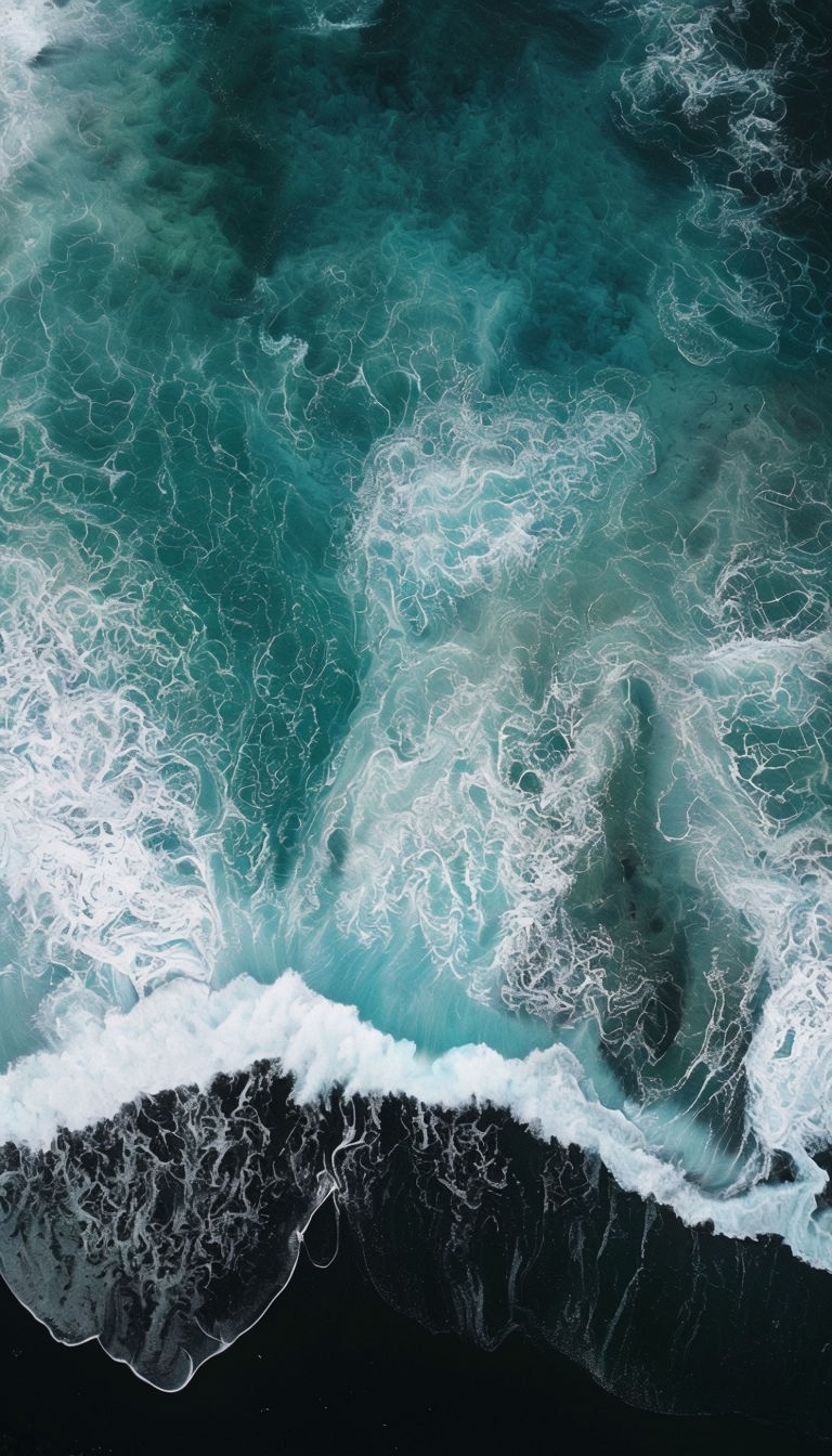 Breathtaking Aerial Ocean Shore View with Dynamic Waves Mobile Wallpaper