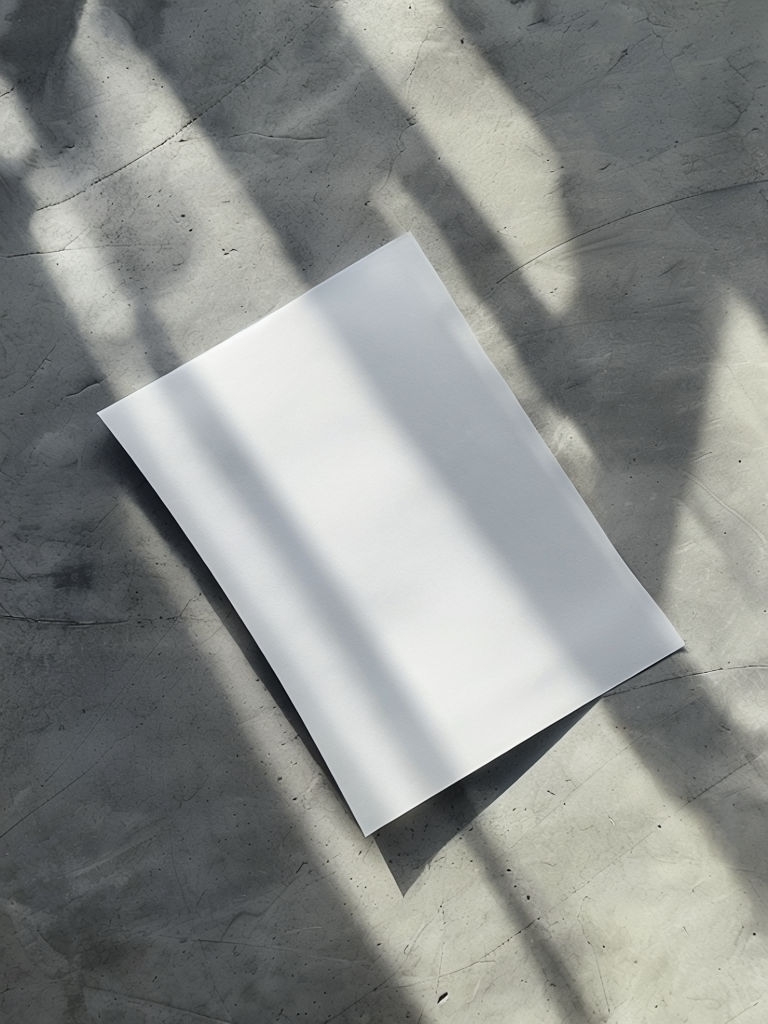 Minimalist White Paper on Gray Surface Mockup