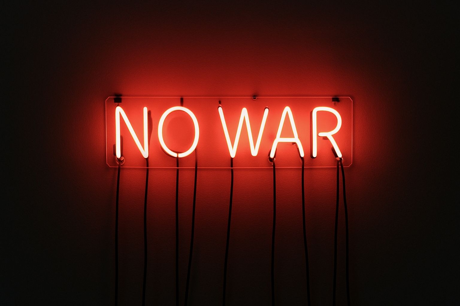 Vibrant Neon 'NO WAR' Sign Against Dark Wall Poster