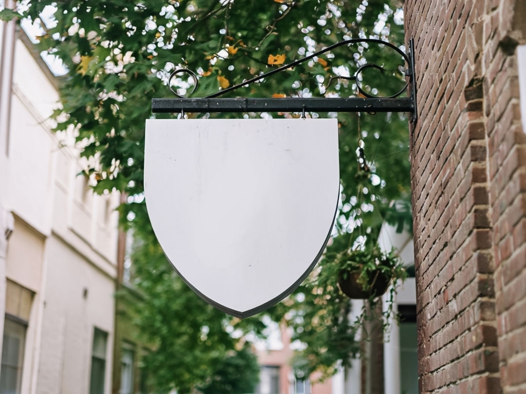 Urban Shield Sign with Autumn Foliage and Alleyway Background Photo Mockup